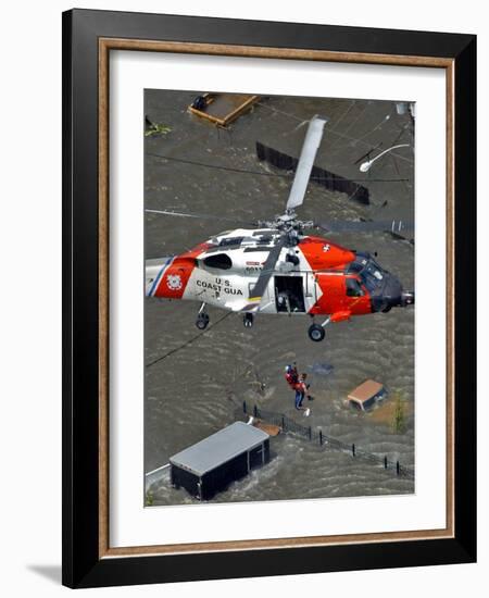 Coast Guard Rescues One from Roof Top of Home, Floodwaters from Hurricane Katrina Cover the Streets-null-Framed Photographic Print