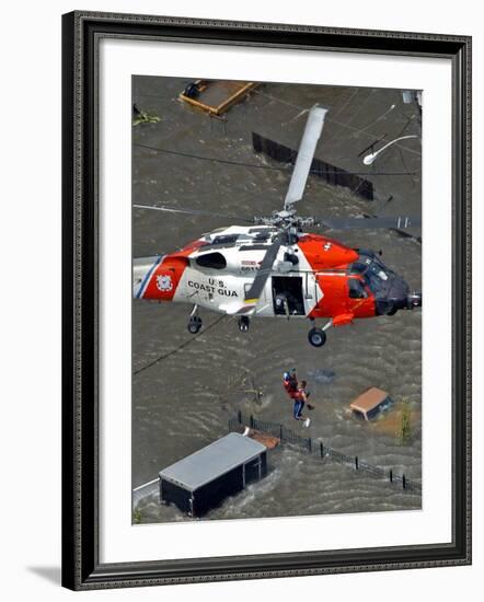 Coast Guard Rescues One from Roof Top of Home, Floodwaters from Hurricane Katrina Cover the Streets-null-Framed Photographic Print