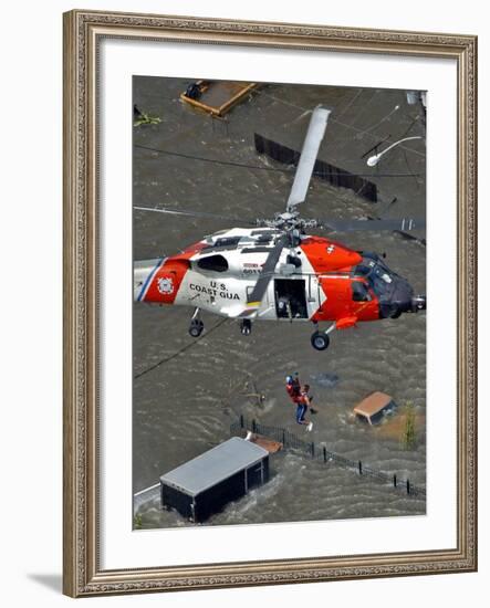 Coast Guard Rescues One from Roof Top of Home, Floodwaters from Hurricane Katrina Cover the Streets-null-Framed Photographic Print