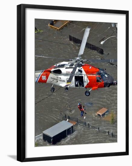 Coast Guard Rescues One from Roof Top of Home, Floodwaters from Hurricane Katrina Cover the Streets-null-Framed Photographic Print