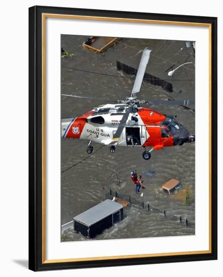 Coast Guard Rescues One from Roof Top of Home, Floodwaters from Hurricane Katrina Cover the Streets-null-Framed Photographic Print