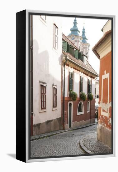 Cobblestone Street and Narrow Buildings with Church Towers in Background, Eger, Hungary-Kimberly Walker-Framed Premier Image Canvas