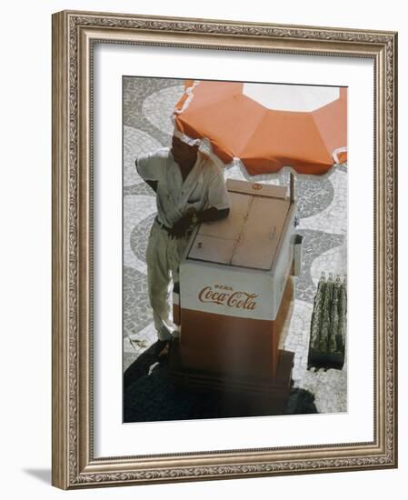 Coca-Cola Vendor Leaning on Cart with Umbrella on Mosaic Sidewalk, Copacabana Beach, Rio de Janeiro-Dmitri Kessel-Framed Photographic Print