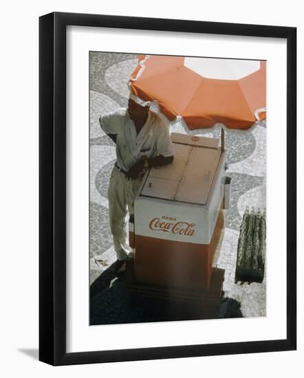 Coca-Cola Vendor Leaning on Cart with Umbrella on Mosaic Sidewalk, Copacabana Beach, Rio de Janeiro-Dmitri Kessel-Framed Photographic Print