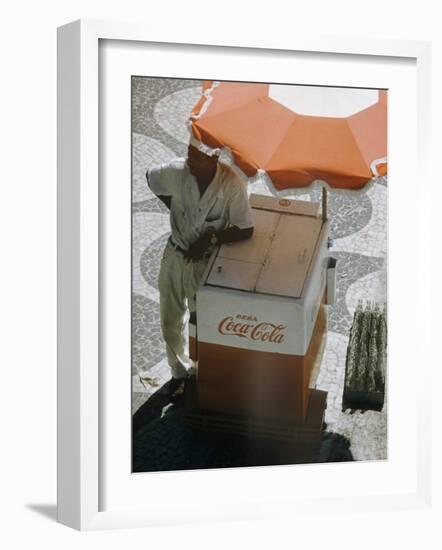 Coca-Cola Vendor Leaning on Cart with Umbrella on Mosaic Sidewalk, Copacabana Beach, Rio de Janeiro-Dmitri Kessel-Framed Photographic Print