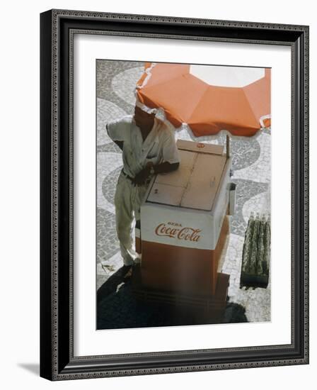 Coca-Cola Vendor Leaning on Cart with Umbrella on Mosaic Sidewalk, Copacabana Beach, Rio de Janeiro-Dmitri Kessel-Framed Photographic Print