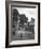 Collie Sheepdog Sitting in Road Leading Up Toward Castle Farm Owned by Beatrix Potter-George Rodger-Framed Photographic Print