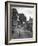 Collie Sheepdog Sitting in Road Leading Up Toward Castle Farm Owned by Beatrix Potter-George Rodger-Framed Photographic Print