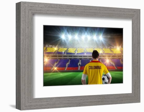 Colombia Football Player Holding Ball against Stadium Full of Colombia Football Fans-Wavebreak Media Ltd-Framed Photographic Print
