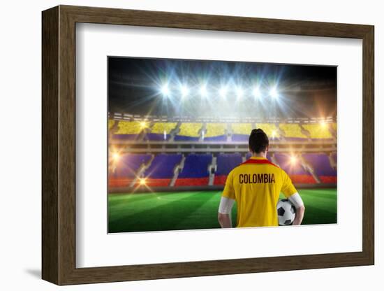 Colombia Football Player Holding Ball against Stadium Full of Colombia Football Fans-Wavebreak Media Ltd-Framed Photographic Print