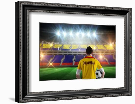 Colombia Football Player Holding Ball against Stadium Full of Colombia Football Fans-Wavebreak Media Ltd-Framed Photographic Print