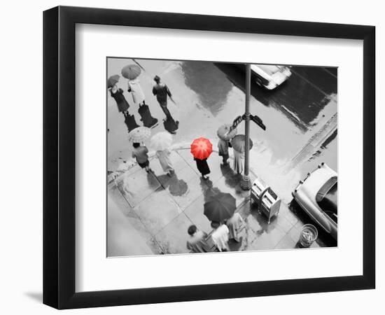 Color Pop,1950s AERIAL OF STREET CORNER IN THE RAIN PEDESTRIANS WITH UMBRELLAS CARS WET PAVEMENT-null-Framed Photographic Print
