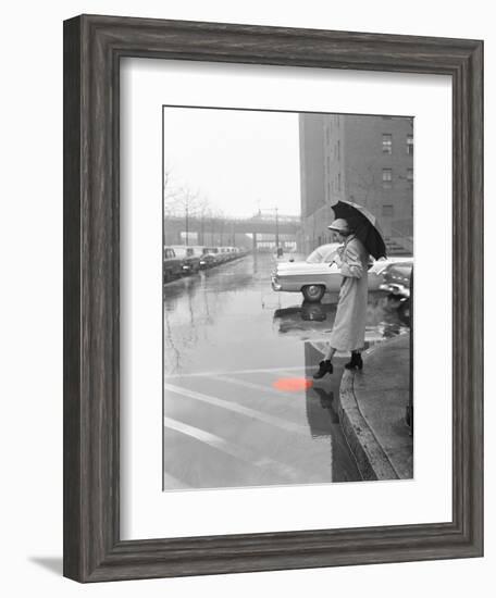 Color Pop,1950s WOMAN IN RAIN COAT HAT BOOTS HOLDING UMBRELLA CROSSING CITY STREET-null-Framed Photographic Print