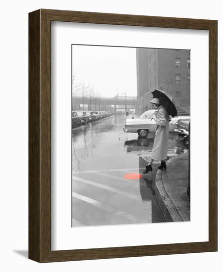 Color Pop,1950s WOMAN IN RAIN COAT HAT BOOTS HOLDING UMBRELLA CROSSING CITY STREET-null-Framed Photographic Print