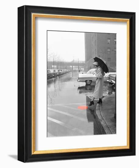 Color Pop,1950s WOMAN IN RAIN COAT HAT BOOTS HOLDING UMBRELLA CROSSING CITY STREET-null-Framed Photographic Print