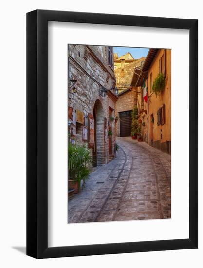 Colored Buildings and Stores Along a Back Street of Spello-Terry Eggers-Framed Photographic Print