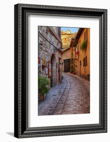 Colored Buildings and Stores Along a Back Street of Spello-Terry Eggers-Framed Photographic Print