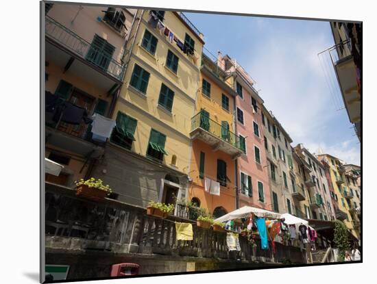 Colorful buildings with clothes hanging out to dry, Riomaggiore, La Spezia, Liguria, Italy-null-Mounted Photographic Print