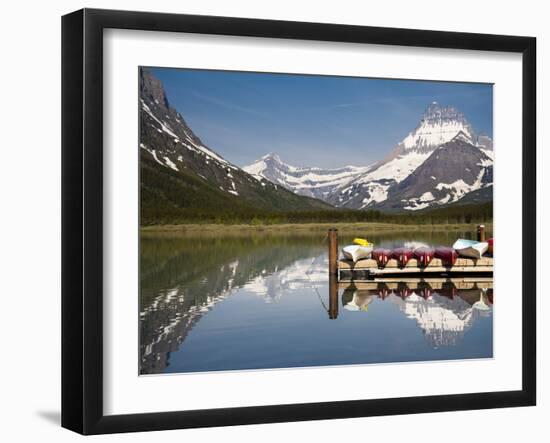 Colorful Canoes Line the Dock at Many Glacier Lodge on Swiftcurrent Lake During Sunrise-Brad Beck-Framed Photographic Print