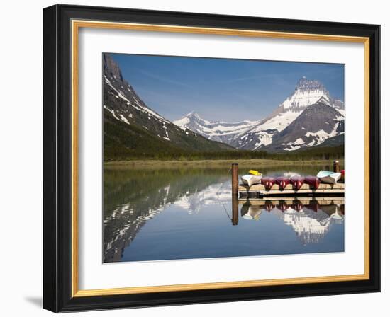 Colorful Canoes Line the Dock at Many Glacier Lodge on Swiftcurrent Lake During Sunrise-Brad Beck-Framed Photographic Print