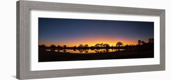 Colorful sunset at watering hole. Camelthorn Lodge. Hwange National Park. Zimbabwe.-Tom Norring-Framed Photographic Print