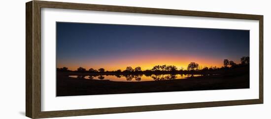 Colorful sunset at watering hole. Camelthorn Lodge. Hwange National Park. Zimbabwe.-Tom Norring-Framed Photographic Print