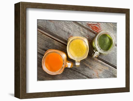 Colorful Trio of Fresh Fruit Juice in Glass Jugs-oocoskun-Framed Photographic Print