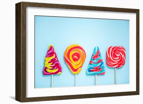 Colorful Vibrant Lollipops, Flat Lay on Blue Background-Marcin Jucha-Framed Photographic Print