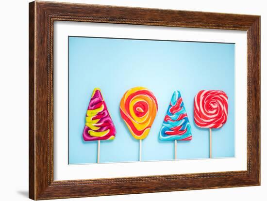 Colorful Vibrant Lollipops, Flat Lay on Blue Background-Marcin Jucha-Framed Photographic Print