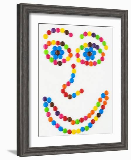 Coloured Chocolate Beans Forming a Smiling Face-Greg Elms-Framed Photographic Print