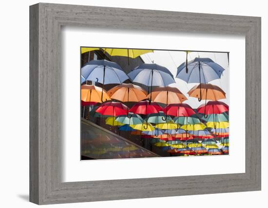 Colourful umbrellas decorate a shopping precinct in England-Charles Bowman-Framed Photographic Print