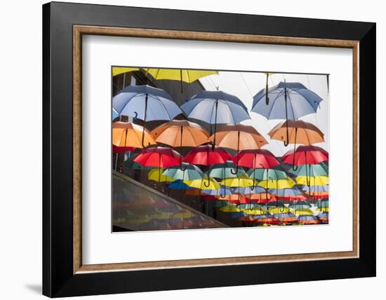 Colourful umbrellas decorate a shopping precinct in England-Charles Bowman-Framed Photographic Print