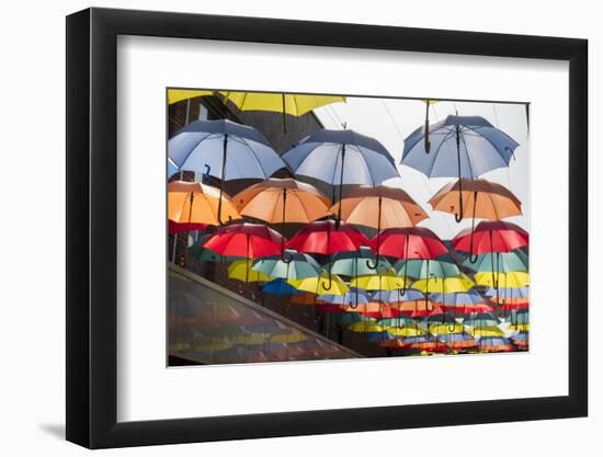 Colourful umbrellas decorate a shopping precinct in England-Charles Bowman-Framed Photographic Print