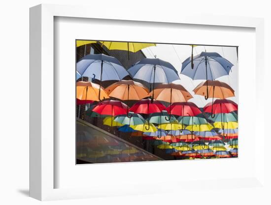 Colourful umbrellas decorate a shopping precinct in England-Charles Bowman-Framed Photographic Print