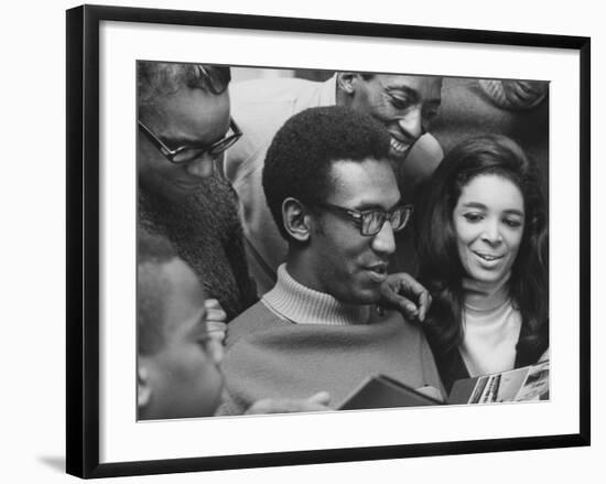 Comedian Bill Cosby Scanning Family Scrapbook with His Wife Camille and Mother-Charles H^ Phillips-Framed Premium Photographic Print