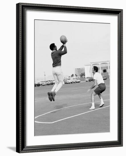 Comedian Bill Cosby Shooting Ball Against His Press Agent, Joe Sutton, During Game of Basketball-Michael Rougier-Framed Premium Photographic Print