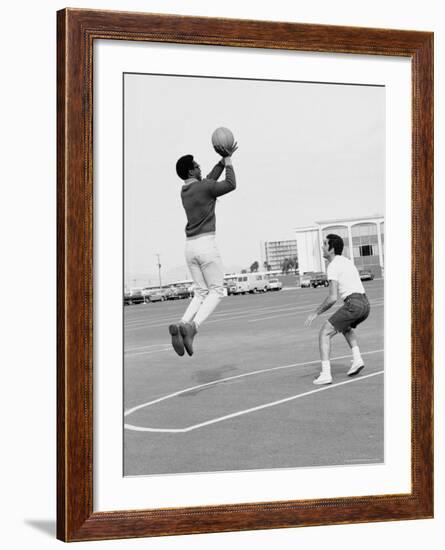 Comedian Bill Cosby Shooting Ball Against His Press Agent, Joe Sutton, During Game of Basketball-Michael Rougier-Framed Premium Photographic Print