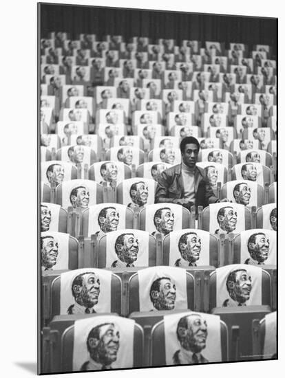 Comedian Bill Cosby Sitting in Empty Auditorium Filled with Copies of His Likeness on Each Seat-Michael Rougier-Mounted Premium Photographic Print