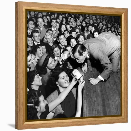 Comedian Milton Berle Trying to Kiss Fans Who Are Asking for Autographs-George Silk-Framed Premier Image Canvas