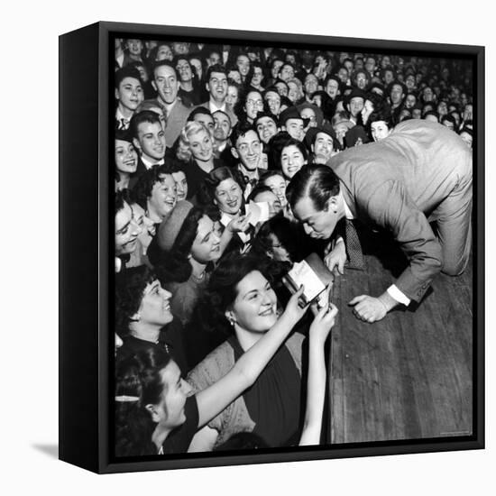 Comedian Milton Berle Trying to Kiss Fans Who Are Asking for Autographs-George Silk-Framed Premier Image Canvas