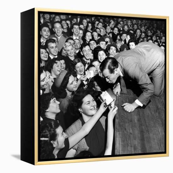 Comedian Milton Berle Trying to Kiss Fans Who Are Asking for Autographs-George Silk-Framed Premier Image Canvas