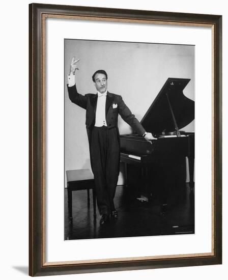 Comedian Pianist Victor Borge, in White Tie and Tails, Standing at Piano and Making Funny Faces-Peter Stackpole-Framed Premium Photographic Print