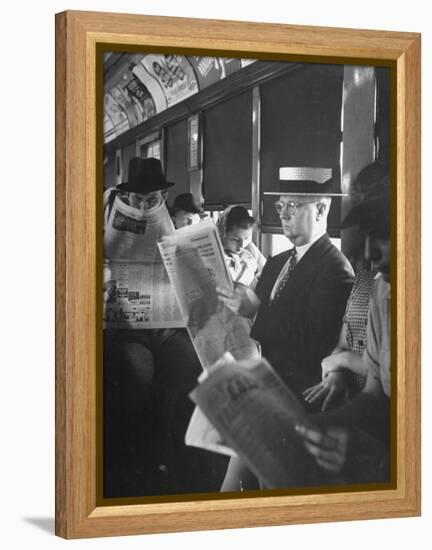 Commuters Sitting on a Train and Reading the Chicago Tribune-Charles E^ Steinheimer-Framed Premier Image Canvas