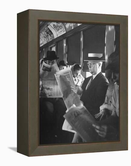 Commuters Sitting on a Train and Reading the Chicago Tribune-Charles E^ Steinheimer-Framed Premier Image Canvas