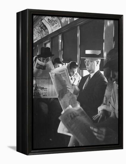 Commuters Sitting on a Train and Reading the Chicago Tribune-Charles E^ Steinheimer-Framed Premier Image Canvas