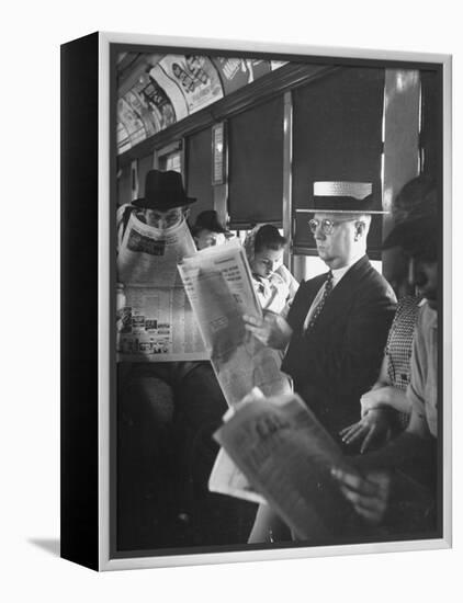 Commuters Sitting on a Train and Reading the Chicago Tribune-Charles E^ Steinheimer-Framed Premier Image Canvas