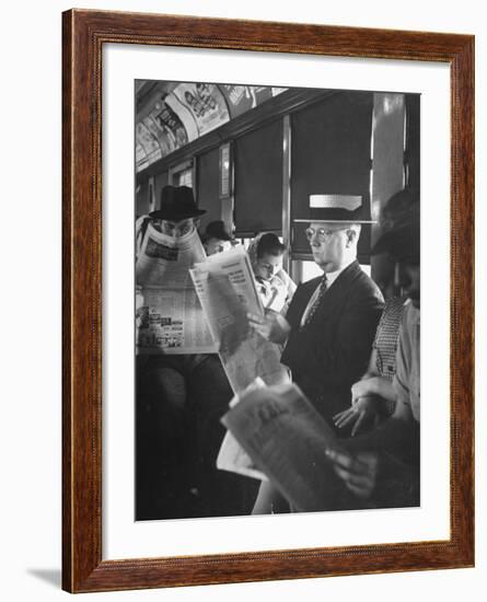 Commuters Sitting on a Train and Reading the Chicago Tribune-Charles E^ Steinheimer-Framed Premium Photographic Print