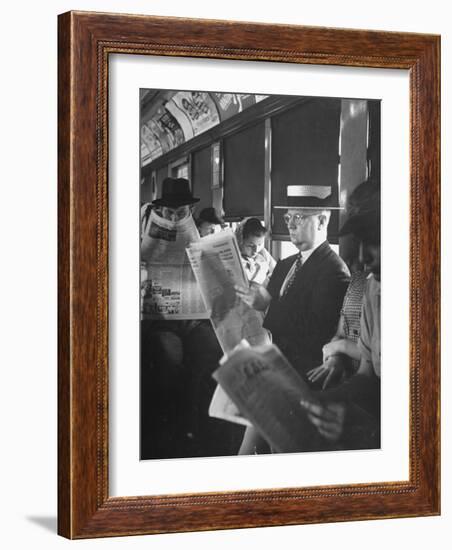 Commuters Sitting on a Train and Reading the Chicago Tribune-Charles E^ Steinheimer-Framed Photographic Print