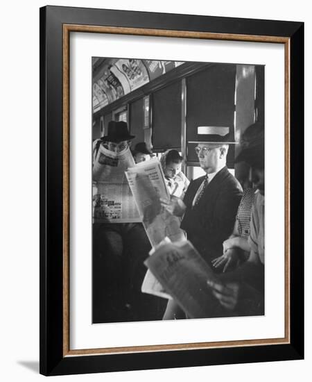 Commuters Sitting on a Train and Reading the Chicago Tribune-Charles E^ Steinheimer-Framed Photographic Print