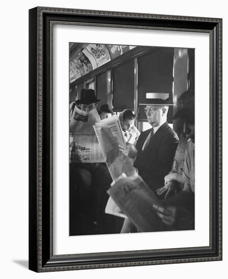 Commuters Sitting on a Train and Reading the Chicago Tribune-Charles E^ Steinheimer-Framed Photographic Print